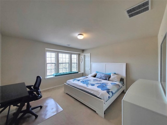 bedroom with baseboards, visible vents, and light colored carpet