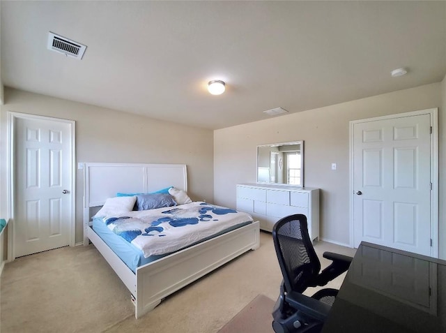 bedroom featuring visible vents and light colored carpet