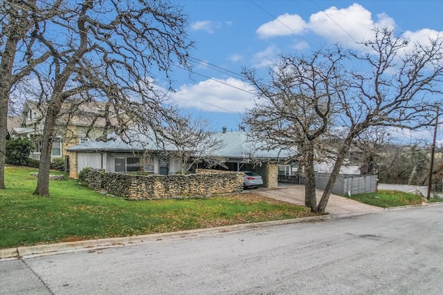 single story home with a front yard and an attached carport