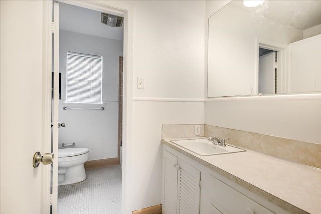 bathroom featuring toilet, visible vents, vanity, and tile patterned floors