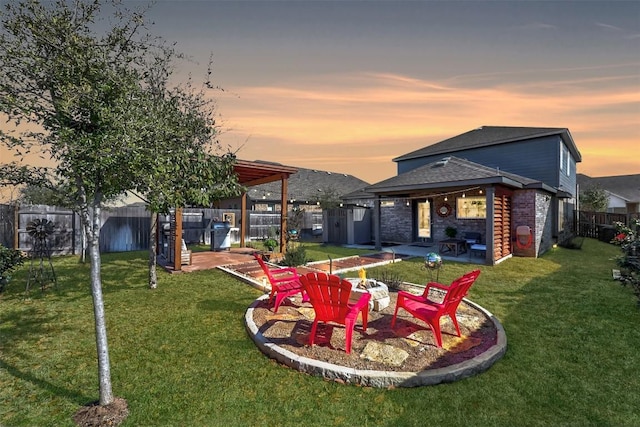 yard at dusk with a patio and a fenced backyard