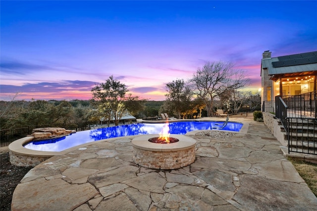 view of swimming pool featuring a fire pit and a patio area