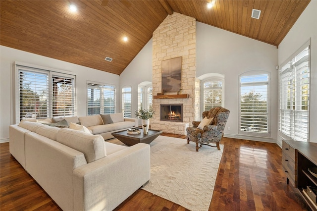 living room featuring visible vents, dark wood finished floors, wooden ceiling, a stone fireplace, and high vaulted ceiling