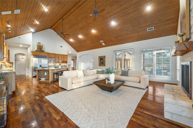 1386 Patterson Rd, Austin, TX 78733 - living room featuring arched walkways, ceiling fan, high vaulted ceiling, a glass covered fireplace, and dark wood-style floors