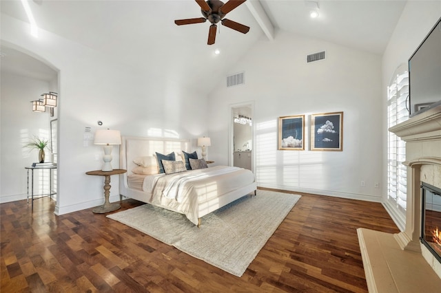 1386 Patterson Rd, Austin, TX 78733 - bedroom featuring a tile fireplace, beamed ceiling, high vaulted ceiling, wood finished floors, and arched walkways