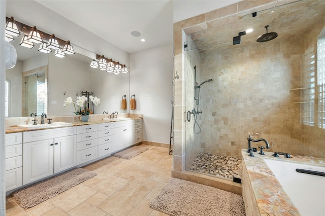 1386 Patterson Rd, Austin, TX 78733 - bathroom featuring a stall shower, double vanity, a garden tub, stone finish flooring, and recessed lighting