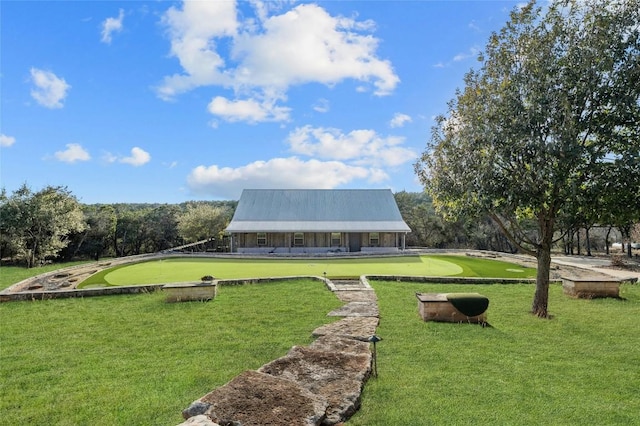 surrounding community featuring a lawn and golf course view