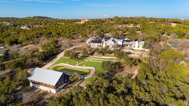 birds eye view of property with a view of trees