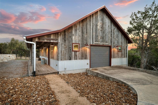 view of home's exterior featuring a garage and concrete driveway