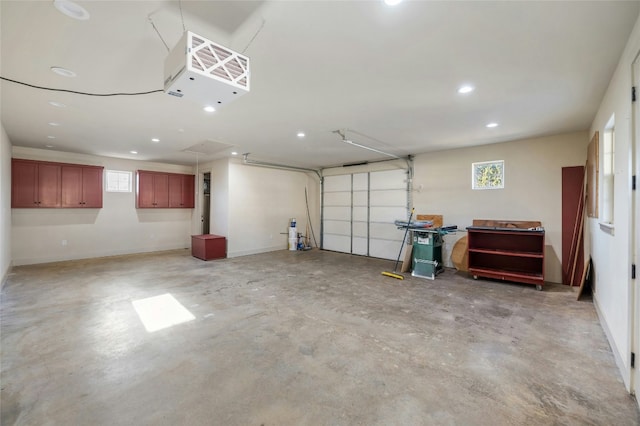 garage featuring baseboards and recessed lighting