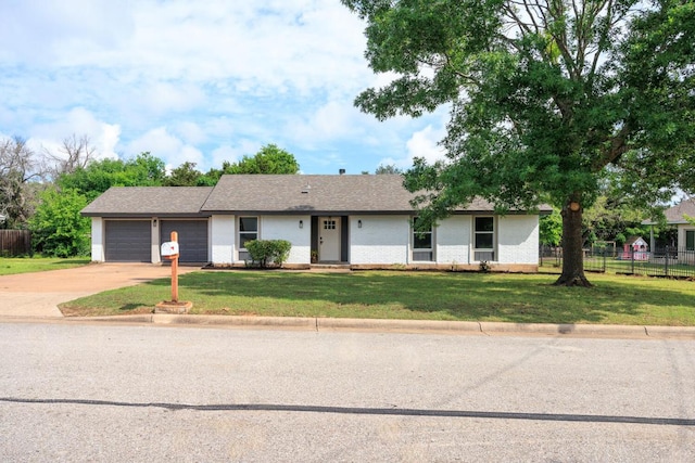 ranch-style house featuring an attached garage, a front yard, and fence