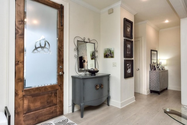 interior space featuring light wood-type flooring, baseboards, and crown molding