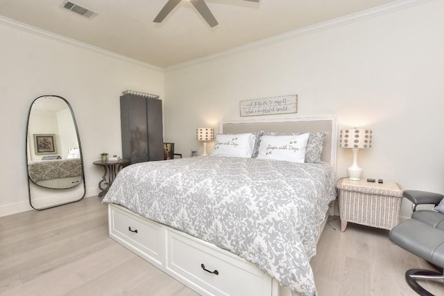 bedroom with baseboards, visible vents, light wood-style flooring, ceiling fan, and crown molding