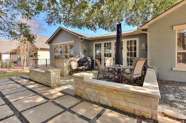 view of patio / terrace featuring french doors, a grill, and fence