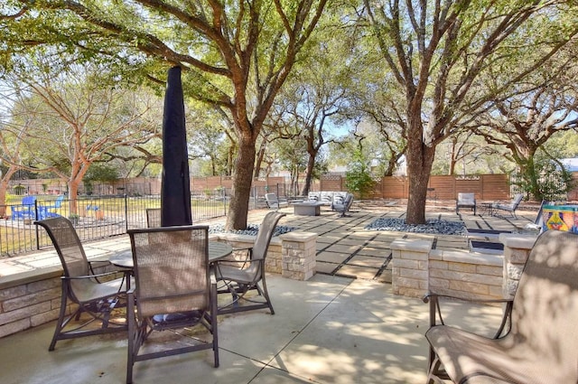 view of patio featuring outdoor dining area and fence