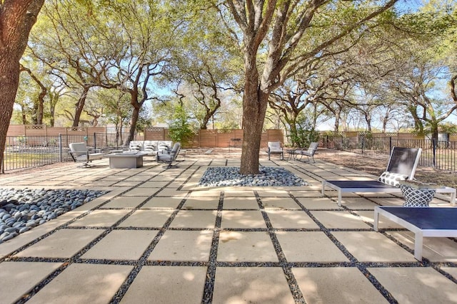 view of patio with an outdoor fire pit and fence