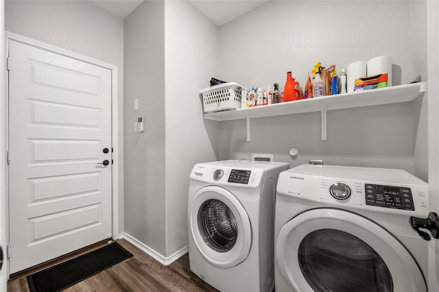 clothes washing area featuring laundry area, independent washer and dryer, dark wood finished floors, and baseboards