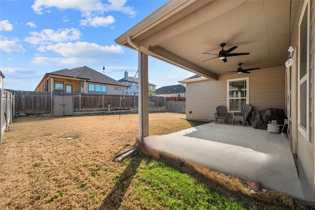 view of yard with a fenced backyard, a patio, and ceiling fan