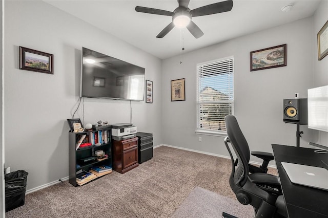 office area with a ceiling fan, baseboards, and carpet flooring