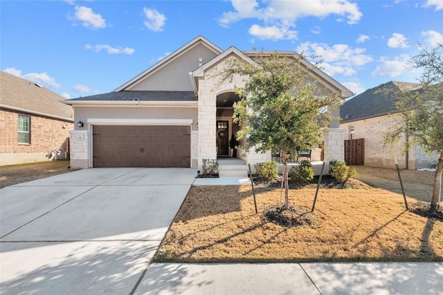 3721 Forino Dr, Round Rock, TX 78665 - view of front of home with an attached garage, stucco siding, concrete driveway, and stone siding