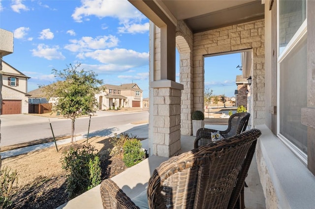 view of patio / terrace with covered porch and a residential view