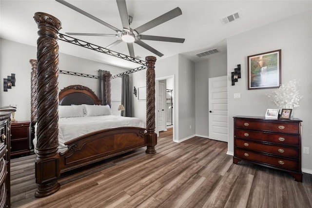 bedroom with visible vents, ceiling fan, baseboards, and wood finished floors