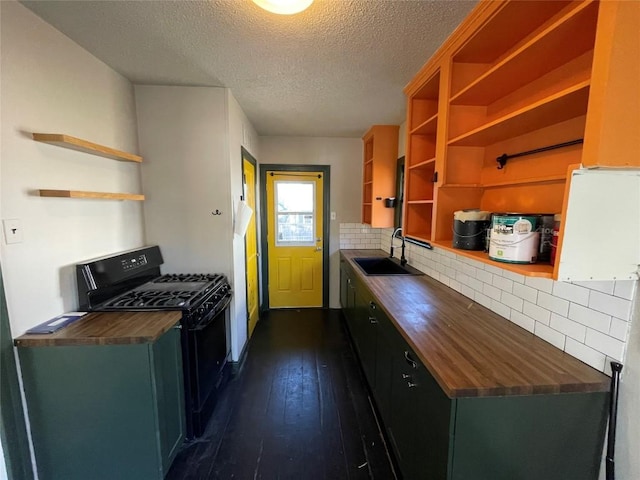 kitchen with black range with gas cooktop, a sink, wooden counters, dark wood-style floors, and open shelves