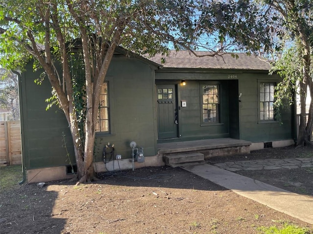 view of front of home featuring crawl space and roof with shingles