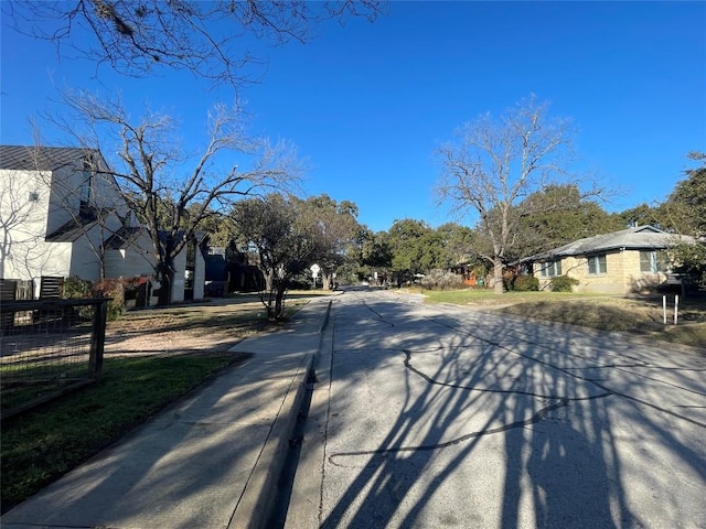 view of road with curbs and a residential view