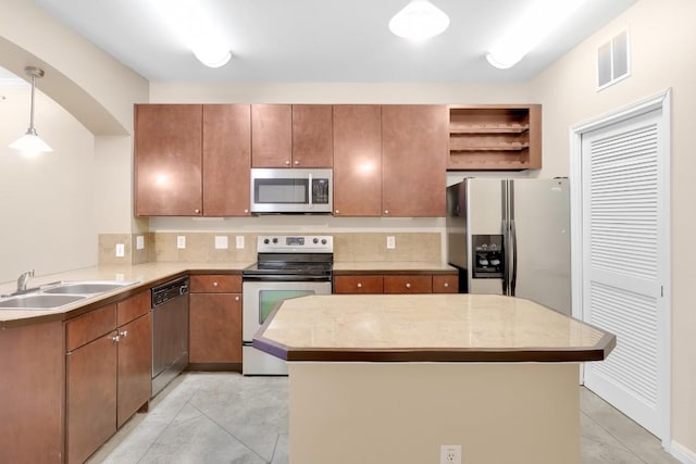 2505 San Gabriel St Unit 212, Austin, TX 78705 - kitchen featuring stainless steel appliances, a sink, tasteful backsplash, light countertops, and hanging light fixtures