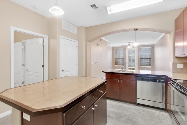 2505 San Gabriel St Unit 212, Austin, TX 78705 - kitchen featuring appliances with stainless steel finishes, a sink, arched walkways, a peninsula, and ceiling fan