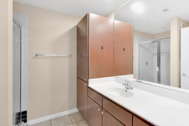 2505 San Gabriel St Unit 212, Austin, TX 78705 - bathroom featuring vanity, a shower with door, tile patterned floors, and baseboards