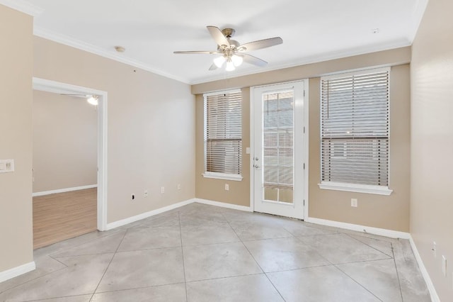 2505 San Gabriel St Unit 212, Austin, TX 78705 - spare room featuring ornamental molding, a ceiling fan, baseboards, and light tile patterned floors