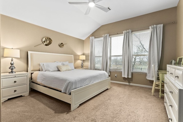 bedroom with light carpet, vaulted ceiling, baseboards, and ceiling fan