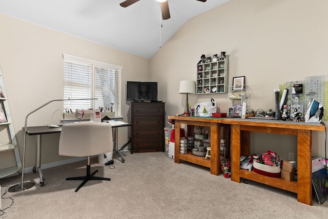 carpeted office space featuring lofted ceiling and a ceiling fan