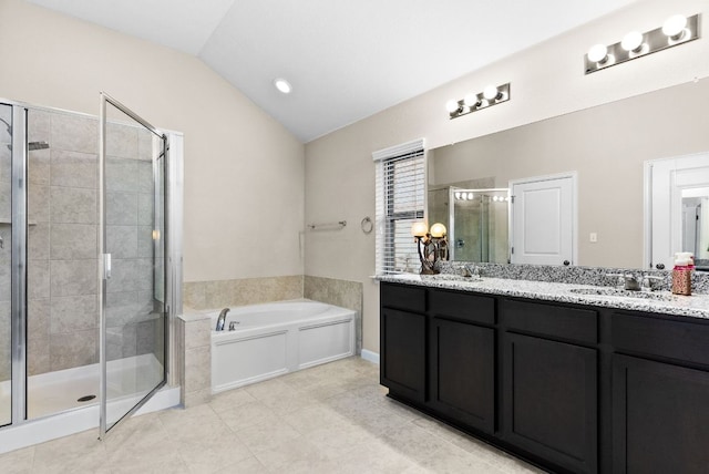 full bath featuring vaulted ceiling, double vanity, a sink, and a garden tub