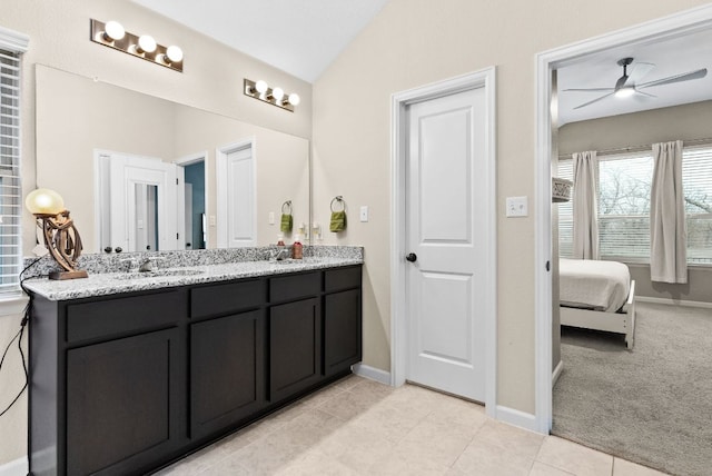 ensuite bathroom featuring ensuite bathroom, lofted ceiling, tile patterned flooring, vanity, and a ceiling fan