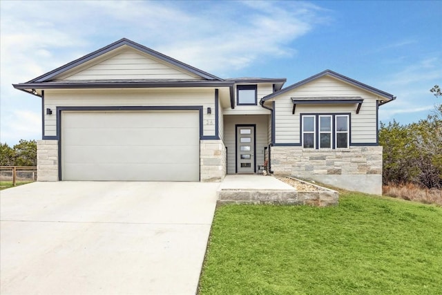 view of front of home with stone siding, a garage, driveway, and a front yard