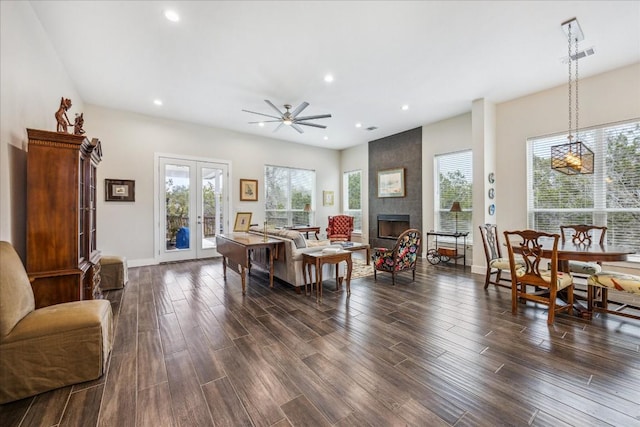 living room with a fireplace, french doors, dark wood-style flooring, and a healthy amount of sunlight