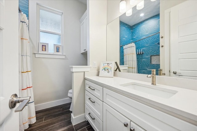 26 Quiet Meadow Cir, Wimberley, TX 78676 - full bathroom featuring vanity, wood finished floors, an accent wall, and curtained shower