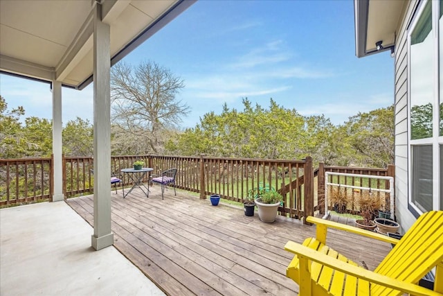 wooden terrace featuring outdoor dining area