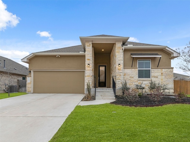 prairie-style home with fence, concrete driveway, stucco siding, stone siding, and an attached garage