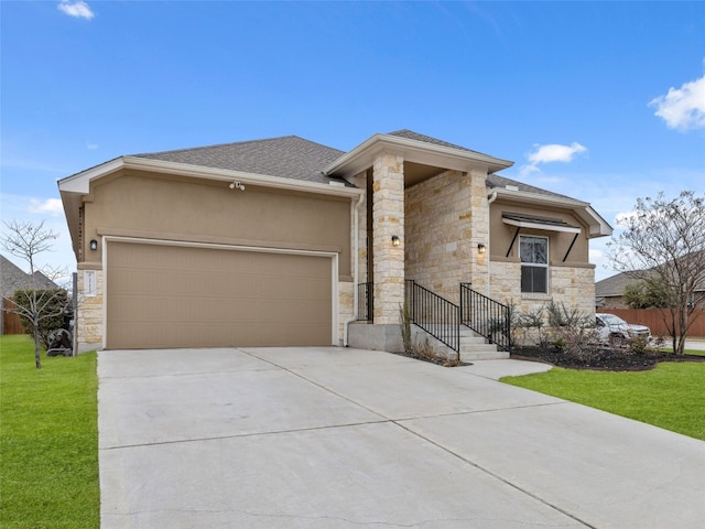 prairie-style home featuring a front yard, an attached garage, stucco siding, concrete driveway, and stone siding