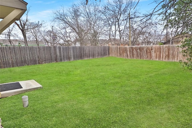 view of yard with a fenced backyard