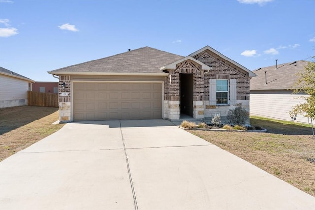 single story home with an attached garage, brick siding, concrete driveway, stone siding, and roof with shingles