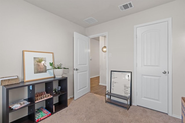 interior space with visible vents and light colored carpet