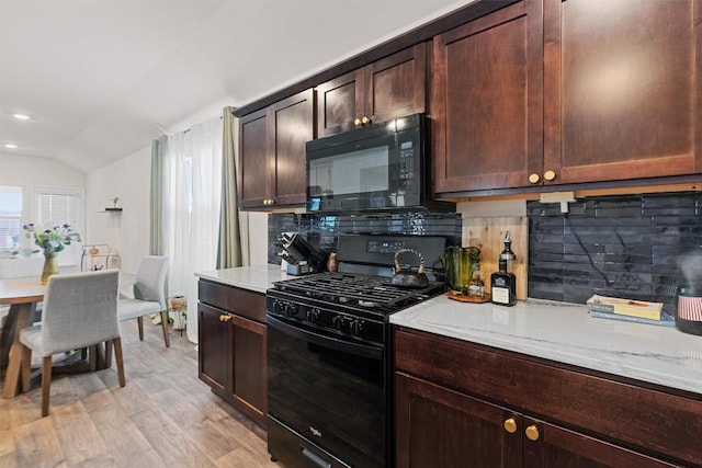 kitchen featuring black appliances, light wood-style floors, backsplash, and light stone countertops