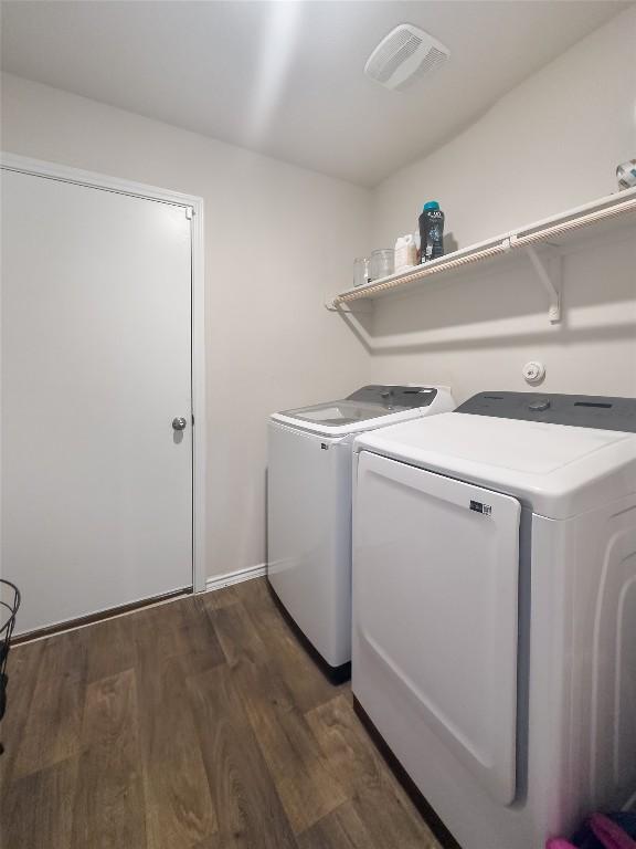 laundry area featuring laundry area, dark wood-style floors, visible vents, and washer and dryer