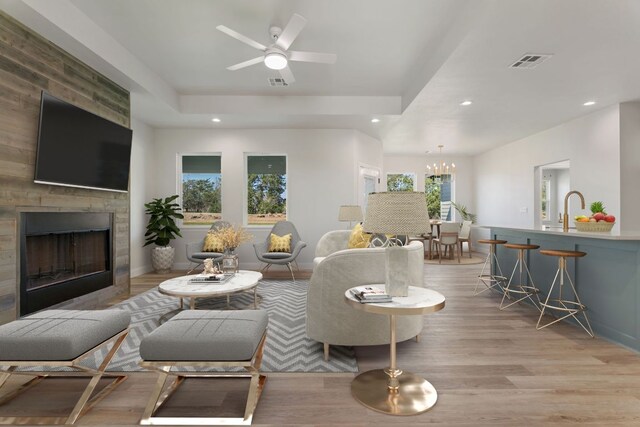 1730 County Road 217, Giddings, TX 78942 - living area featuring a large fireplace, recessed lighting, light wood-type flooring, ceiling fan, and a chandelier