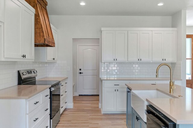 1730 County Road 217, Giddings, TX 78942 - kitchen with stainless steel range with electric stovetop, dishwashing machine, light countertops, light wood-style flooring, and recessed lighting